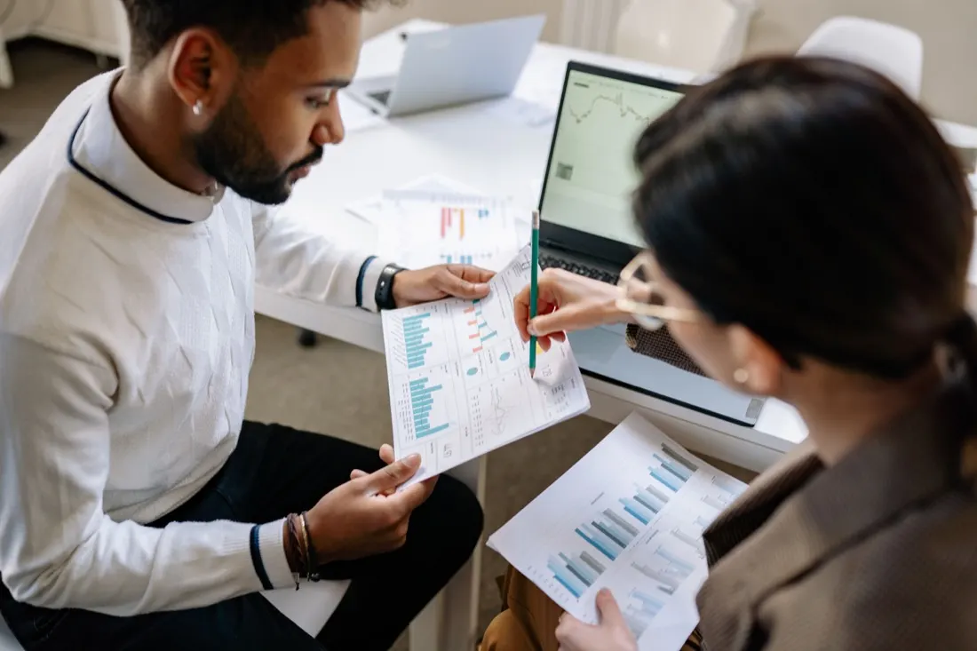 Marketing team reviewing analytics charts on a laptop