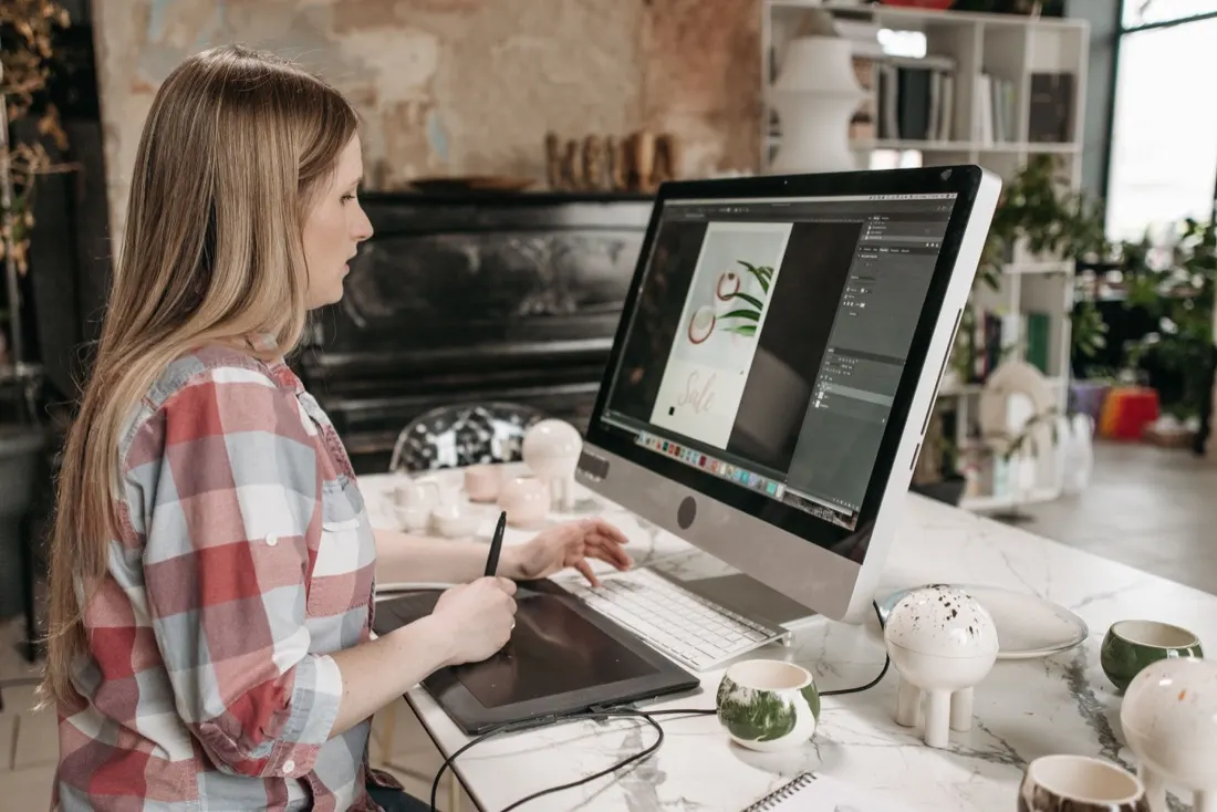 Indianapolis web designer crafting UI layouts on a drawing tablet