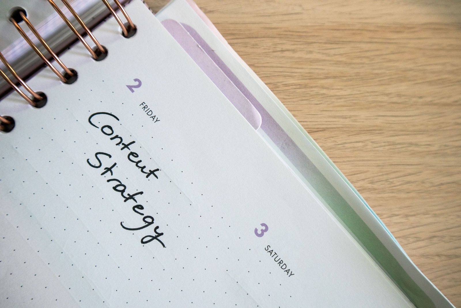 Notebook open to a handwritten content strategy plan on a desk