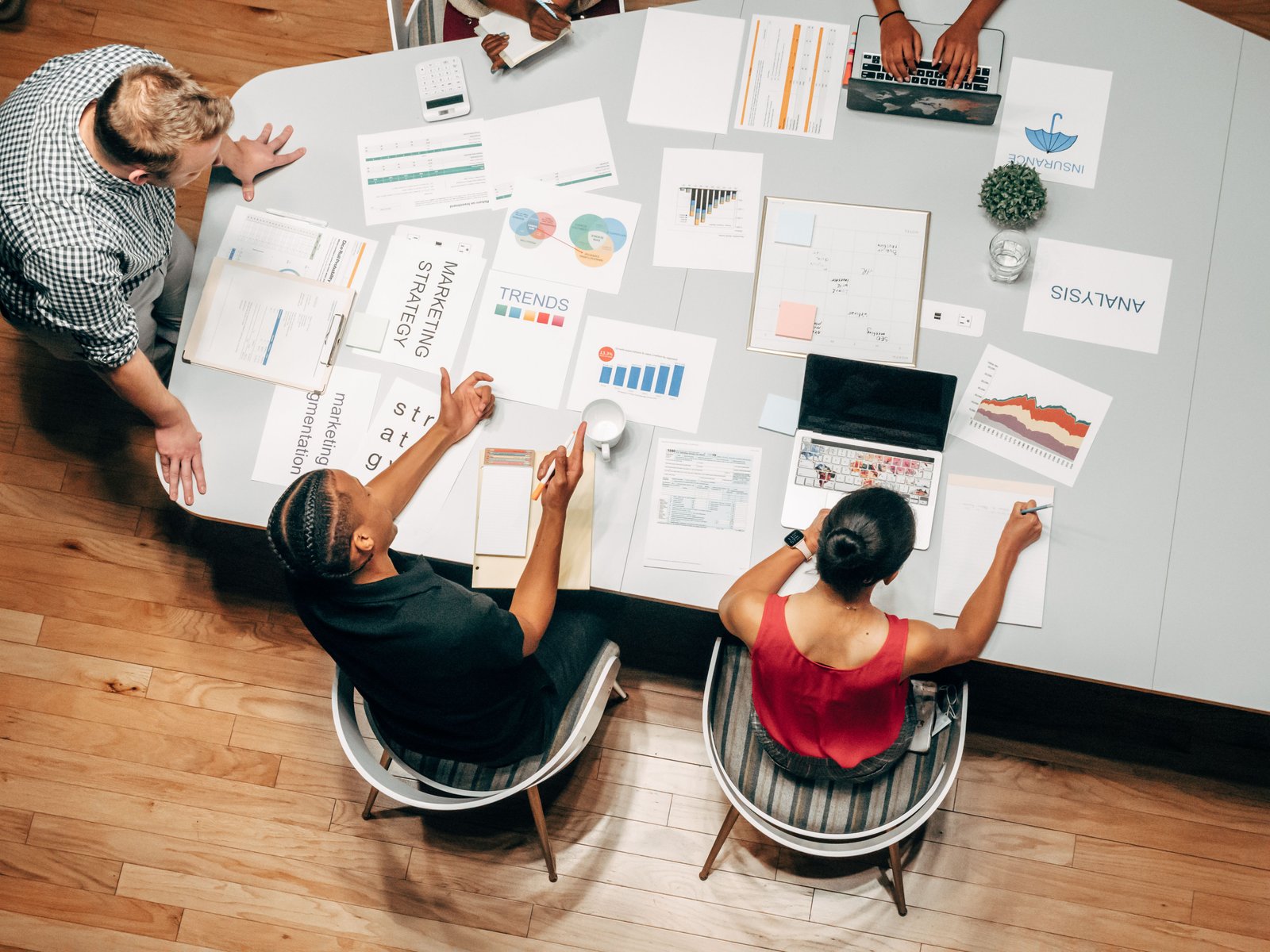 Cross-functional marketing planning session with reports