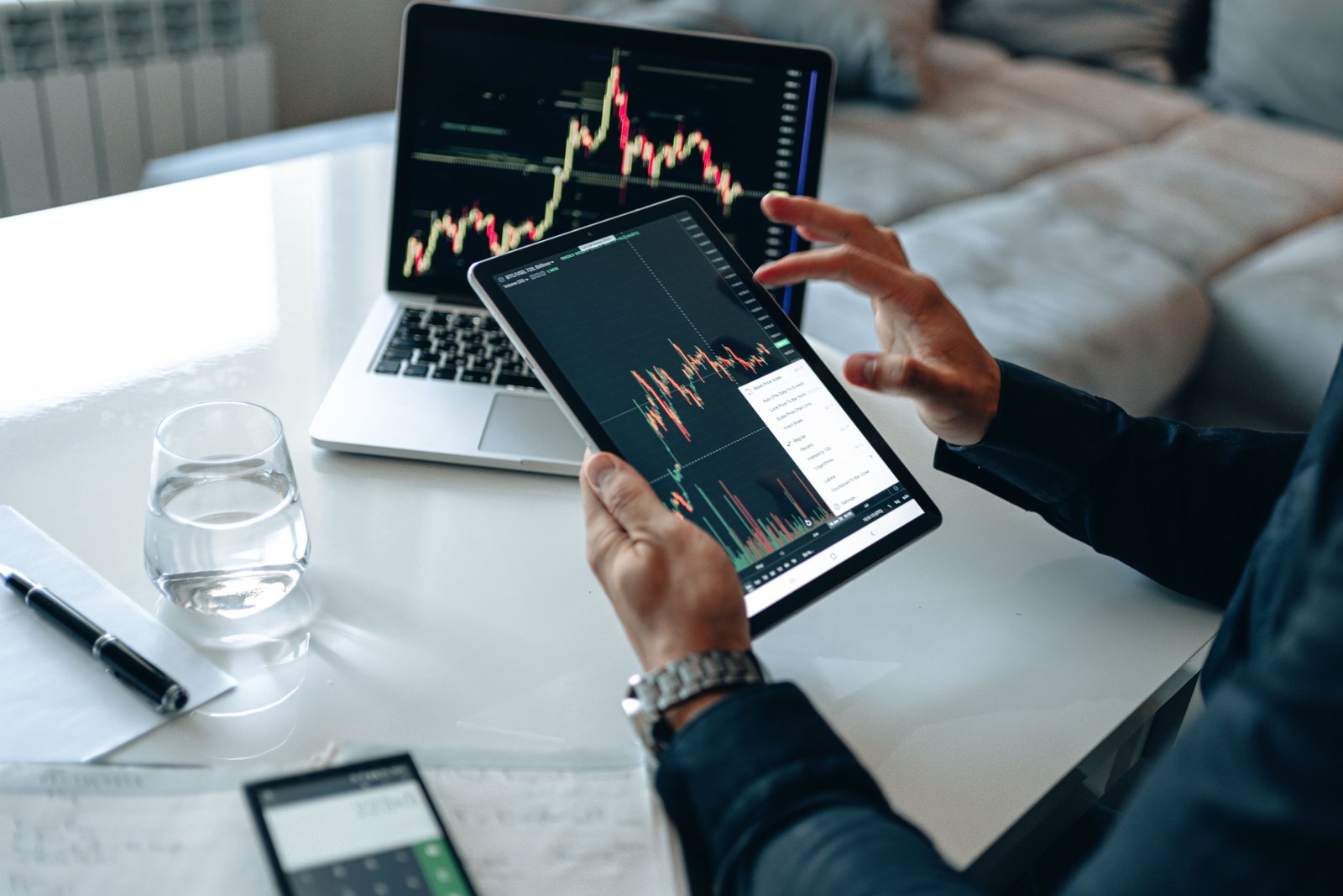 Marketer analyzing performance on a tablet and laptop